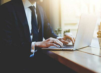 business man in suit using laptop