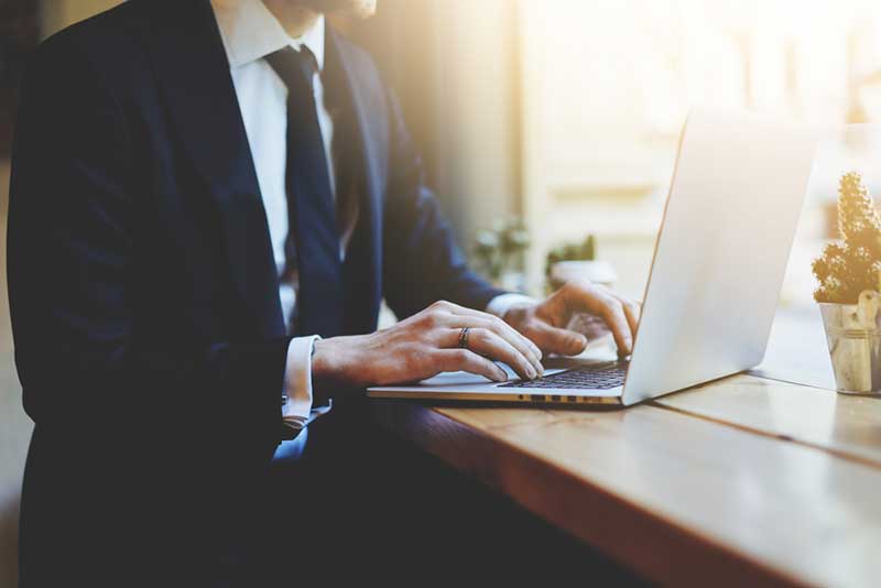 business man in suit using laptop